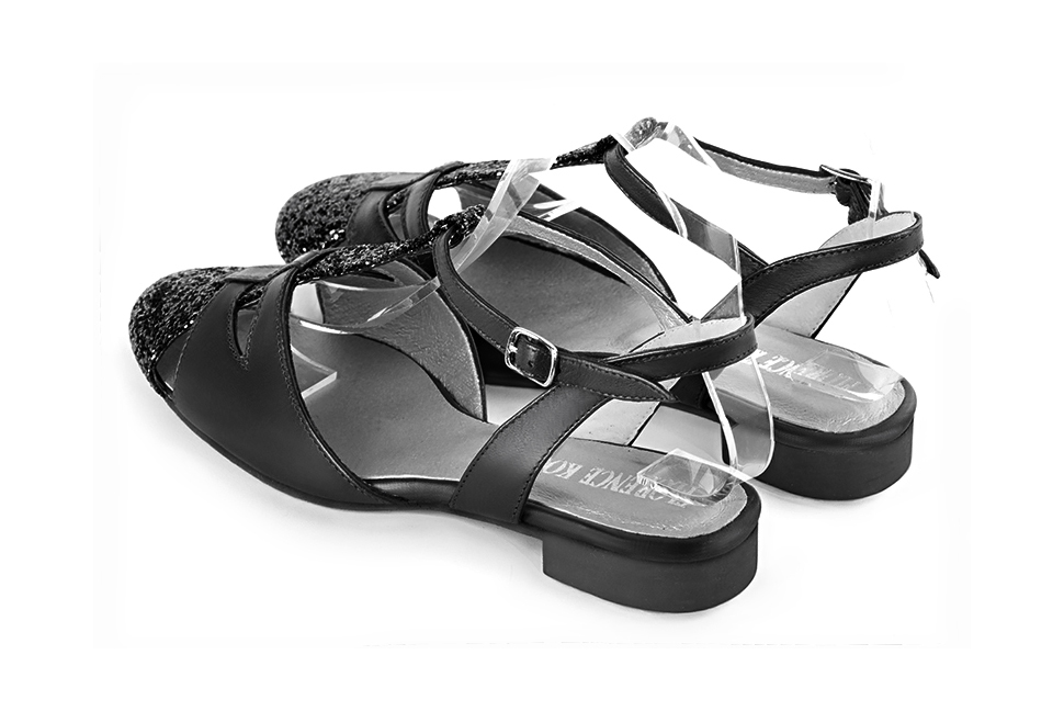 Gloss black women's open back T-strap shoes. Round toe. Flat leather soles. Rear view - Florence KOOIJMAN